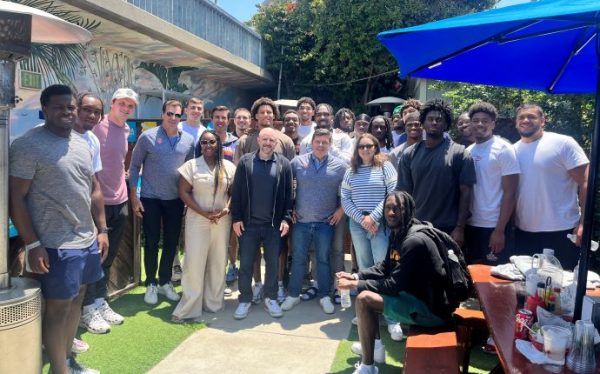 group of students and alumni gather outdoors