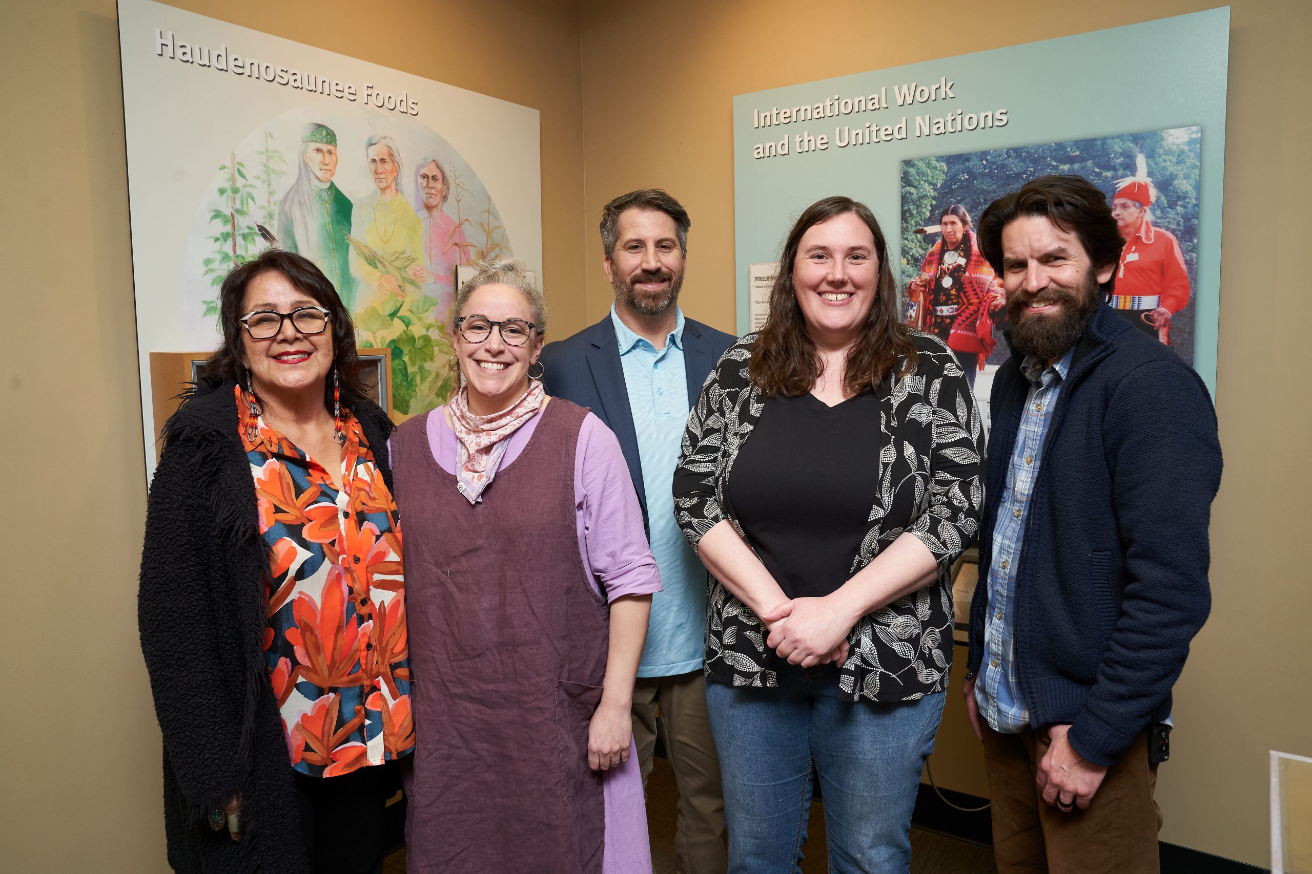 Five people standing together in a museum