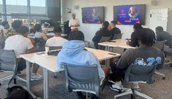 speaker talks to group of students in classroom