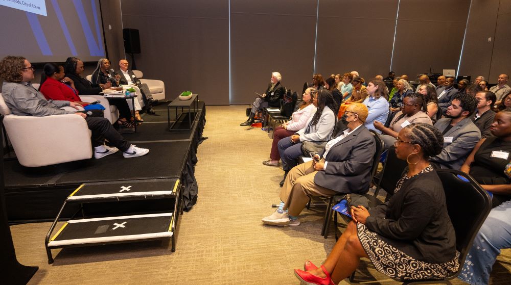 panel of speakers with large audience