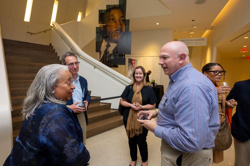 group of people talk at a reception
