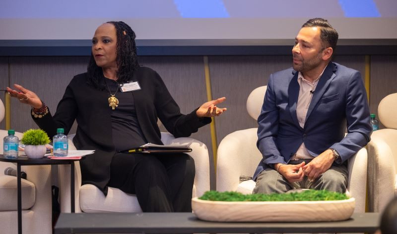woman with outstretched hands and man speak in discussion