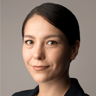 A woman smiles while posing for a headshot.