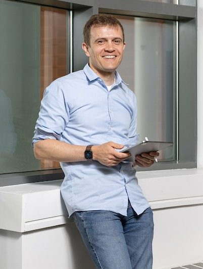 person standing up with a laptop computer