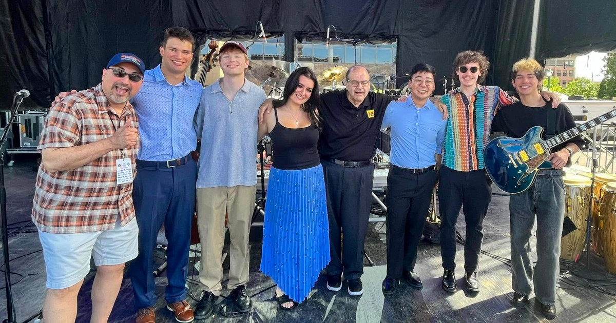 Group of people standing together on a performance stage