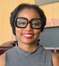 woman with hair pulled back and big black eyeglasses