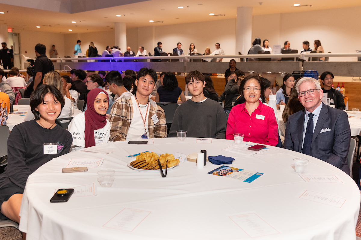 Group of people sitting at a table in the Schine