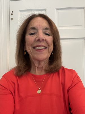 A woman smiles for a headshot.