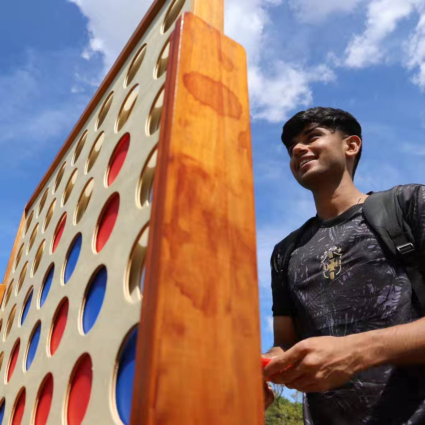 Student playing a large connect 4 game