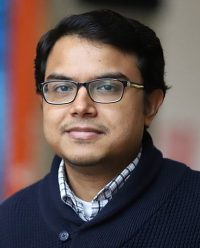 man with glasses looking at camera