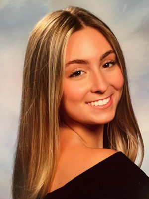 A woman smiles while posing for a headshot.
