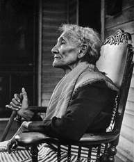 profile black-and-white photograph of an elderly woman in a chair