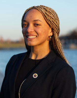 A woman smiles while posing for a headshot.