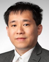 man with white shirt and suit coat looking at camera