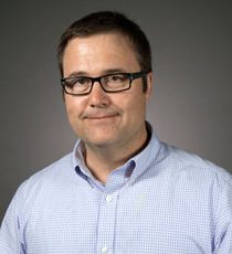 man with glasses and light shirt