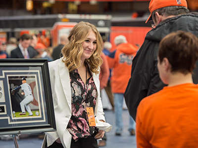 Student greeting customers at the Charity Sport Auction