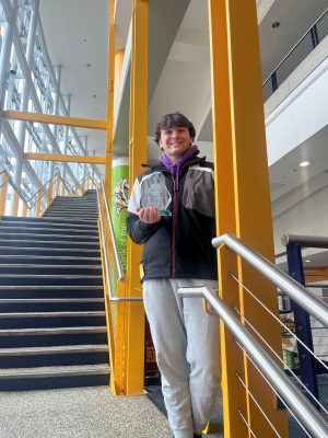 Jonah Soos with the trophy he earned for winning the undergraduate business analytics division.