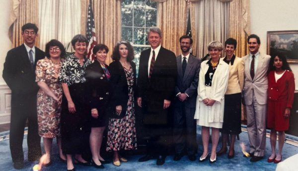 Phyllis Greenberger standing with President Bill Clinton and nine other people in the Oval Office at the White House 