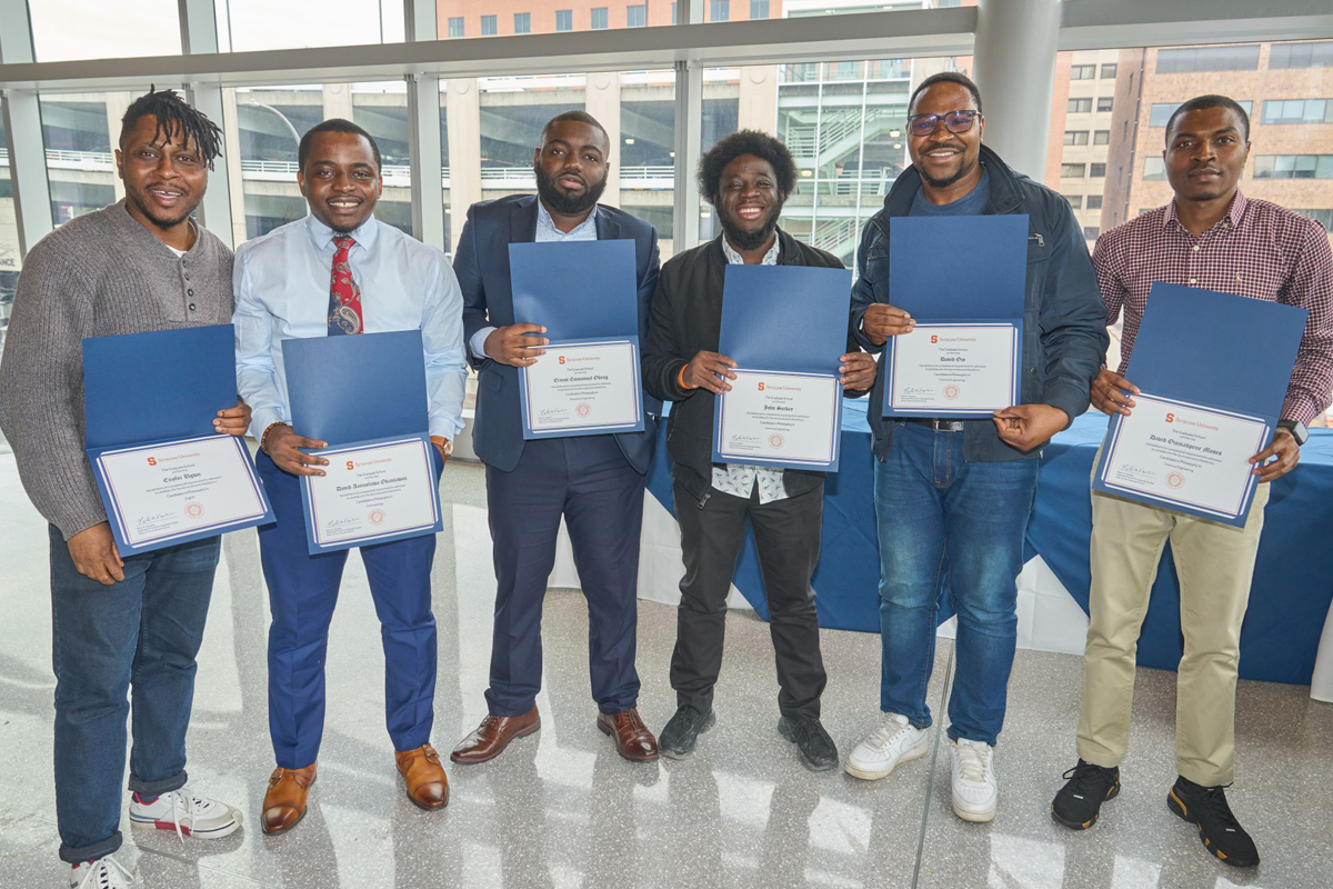 Six doctoral candidates pose for photos.