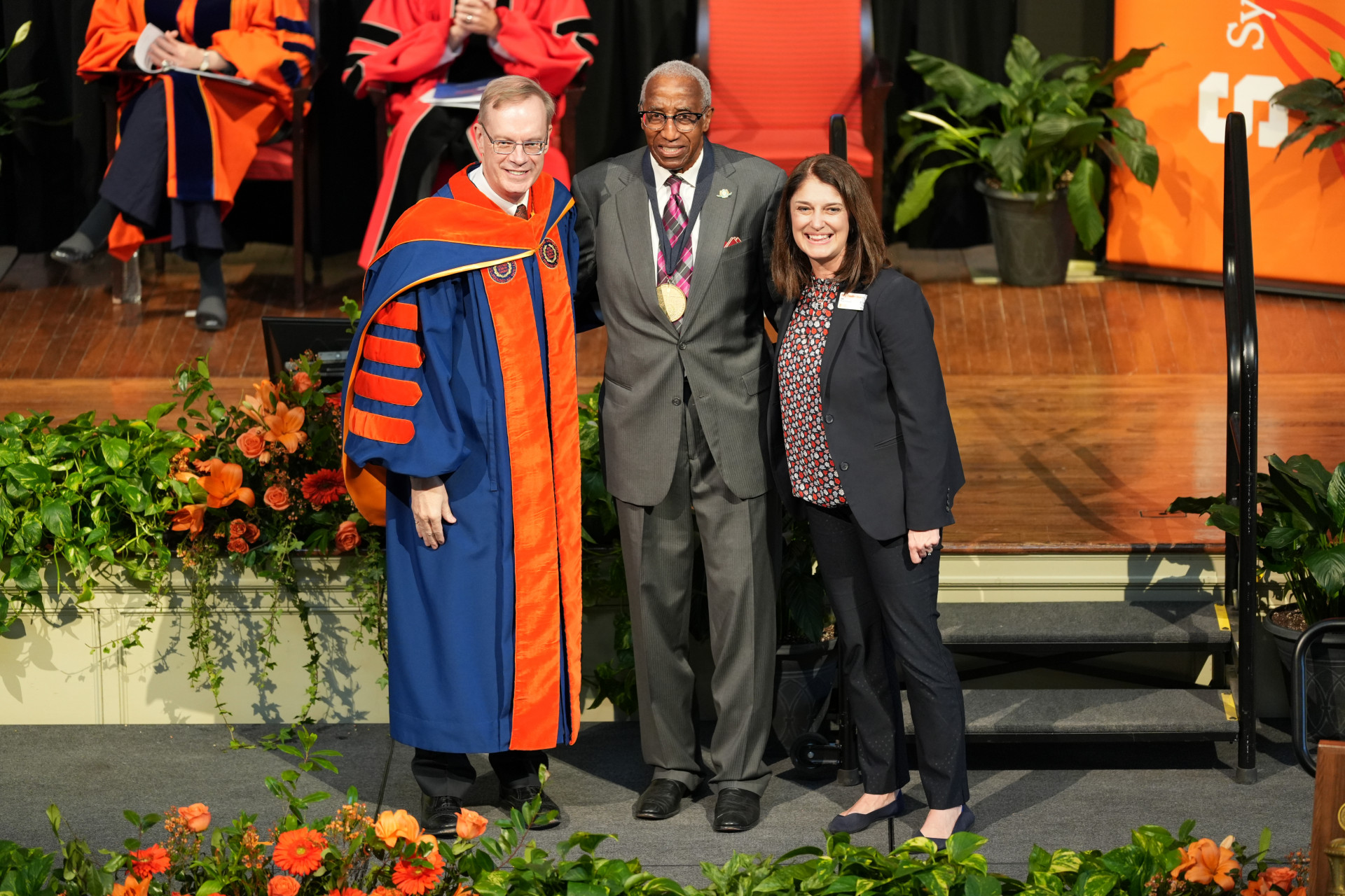 Howard G. Adams G'69 receives the Tolley Medal from Chancellor Syverud and Kelly Chandler-Olcott, dean of the School of Education