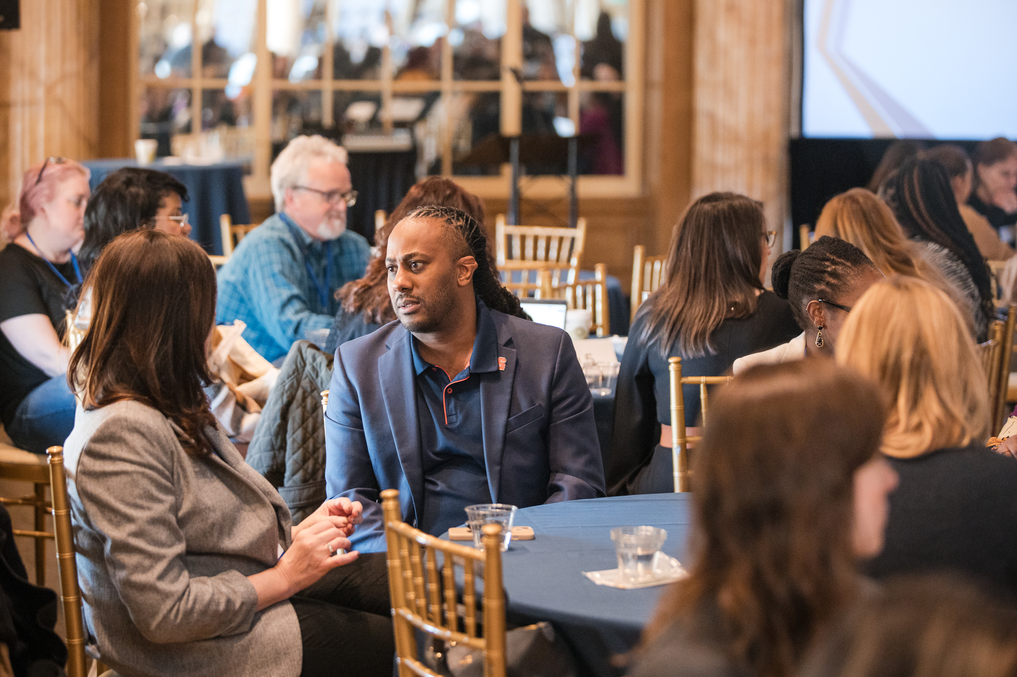 Community members sit around a table and discuss issues during the Lender Center Symposium.