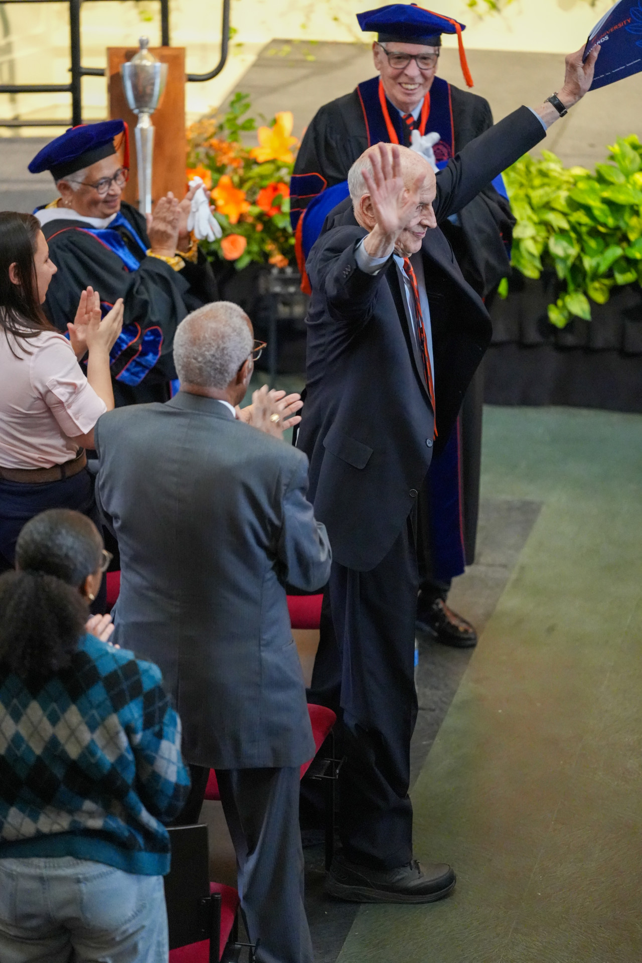 Bill Coplin, professor of policy studies in the Maxwell School of Citizenship and Public Affairs, acknowledges the audience upon the announcement of his 55 years of service to the University