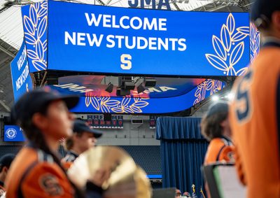 SU Marching Band with Welcome New Students on Jumbotron in the JMA Wireless Dome