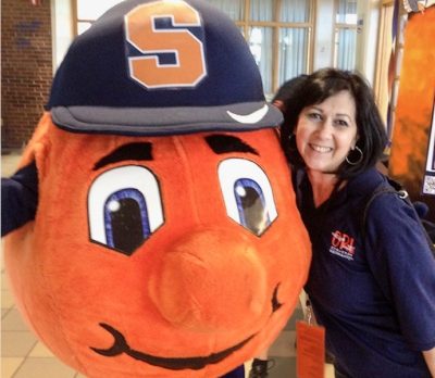 Otto the Orange with a dark-haired women wearing a blue shirt